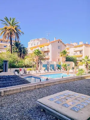 a resort with a swimming pool and some buildings at Studio Latour Maubourg in Cannes