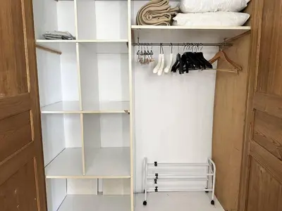a walk in closet with white shelves at Cannes La Croisette - PALAIS MIRAMAR - Studio au calme coté jardin in Cannes