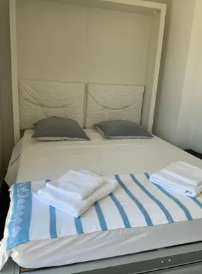 a bed with towels sitting on top of it at Toit terrasse dans résidence avec piscine in Cannes