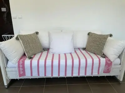 a white couch with pillows on top of it at Toit terrasse dans résidence avec piscine in Cannes