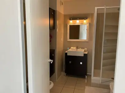 a bathroom with a sink and a mirror at Toit terrasse dans résidence avec piscine in Cannes