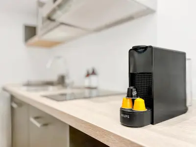 a kitchen counter with a black and yellow object on it at L’Iris - Suquet Cannes Centre in Cannes