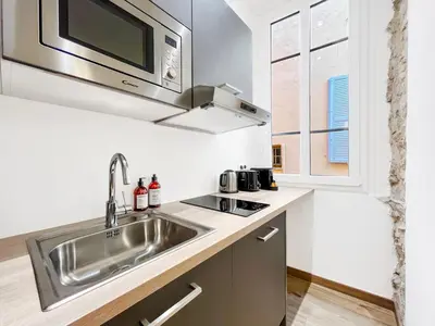 a kitchen with a sink and a microwave at L’Iris - Suquet Cannes Centre in Cannes