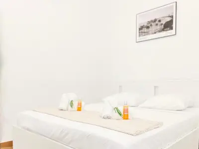 two white beds with towels on top of them at L’Iris - Suquet Cannes Centre in Cannes