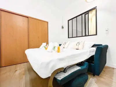 a hospital room with a bed and a mirror at L’Iris - Suquet Cannes Centre in Cannes