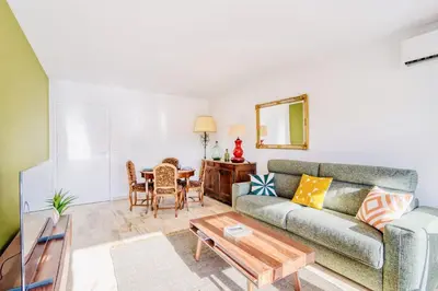 a living room with a couch and a table at L'Étrier-Cannes Centre Terrasse in Cannes