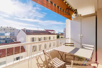 a balcony with a table and chairs on a building at L'Étrier-Cannes Centre Terrasse in Cannes