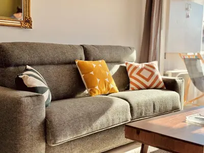 a living room with a couch with pillows on it at L'Étrier-Cannes Centre Terrasse in Cannes