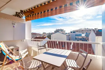 a balcony with a table and chairs and a view at L'Étrier-Cannes Centre Terrasse in Cannes