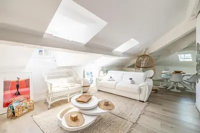 a living room with white furniture and a vaulted ceilings at WELCOME - Stunning 2-bedroom at 5 minutes from Palais des Festivals in Cannes