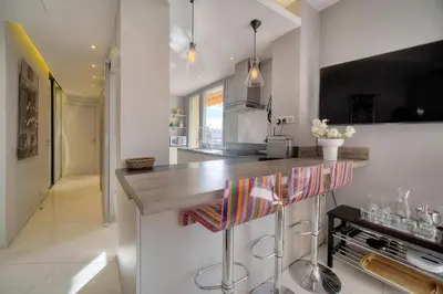 a dining room with a table and views of the city at L'Edmond - 2min Plage - VCA in Cannes