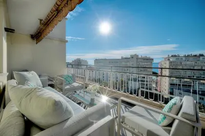 a living room with a couch and a table at L'Edmond - 2min Plage - VCA in Cannes