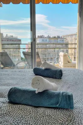 three beds in a room with a view of a city at L'Edmond - 2min Plage - VCA in Cannes