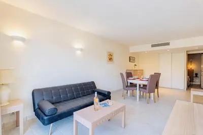 a living room with a couch and a table at L'Excel Canne's - 3 pièces Cannes in Cannes