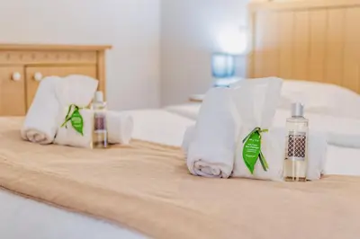 a hotel room with towels and bottles of water on a bed at L'Excel Canne's - 3 pièces Cannes in Cannes