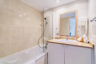 a bathroom with a shower and a sink and a tub at L'Excel Canne's - 3 pièces Cannes in Cannes