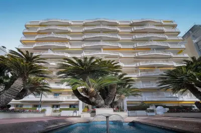 a kitchen with white cabinets and a microwave at Le Ed- Croisette - Parking - VCA in Cannes