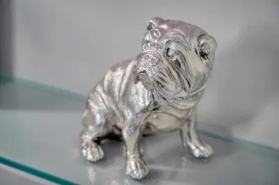 a silver figurine of a dog sitting on a table at Le Ed- Croisette - Parking - VCA in Cannes