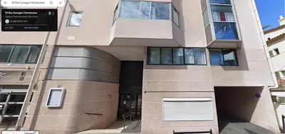 a large building with a garage in front of it at Superbe Appartement avec terrasse 2 chambres, 4 à 5 couchages piscine, à deux pas des plages et de la Croisette in Cannes