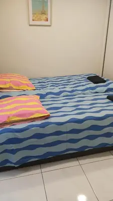 a bed with blue and white sheets and pillows at Superbe Appartement avec terrasse 2 chambres, 4 à 5 couchages piscine, à deux pas des plages et de la Croisette in Cannes