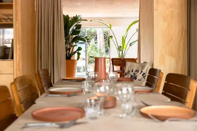 a long table with plates and napkins on it at MOB HOTEL Cannes in Cannes