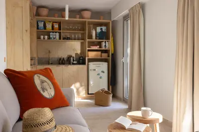 a living room with a couch and a refrigerator at MOB HOTEL Cannes in Cannes