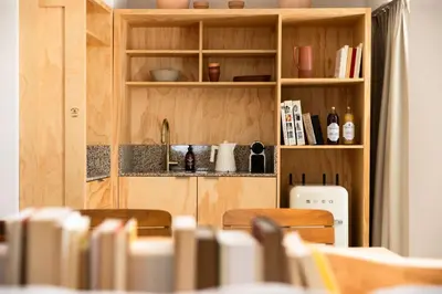 a kitchen with wooden cabinets and a table with chairs at MOB HOTEL Cannes in Cannes