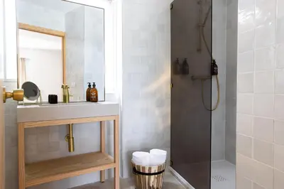 a bathroom with a shower and a sink and a mirror at MOB HOTEL Cannes in Cannes