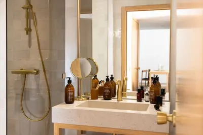 a bathroom with a sink with a mirror and a shower at MOB HOTEL Cannes in Cannes
