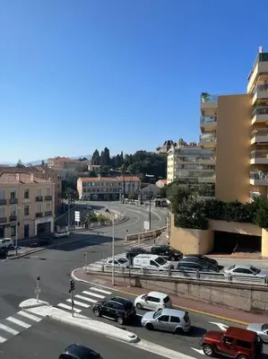 a busy city street with cars parked on the road at Studio lumineux à 2 mn à pied de la plage in Cannes