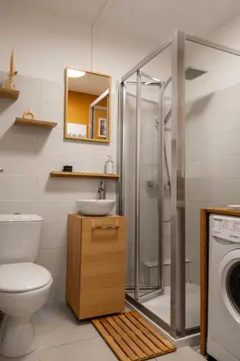 a bathroom with a toilet and a sink and a washing machine at Studio lumineux à 2 mn à pied de la plage in Cannes