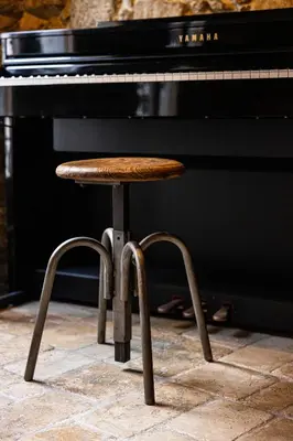 a stool sitting in front of a piano at Triplex 150m2 coeur vieille ville in Cannes