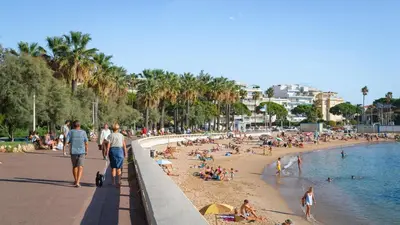 a group of people on a beach near the water at GuestRoom - Chambre d'hôte in Le Cannet