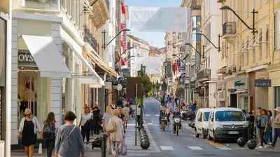 a busy city street with people walking on the sidewalk at GuestRoom - Chambre d'hôte in Le Cannet