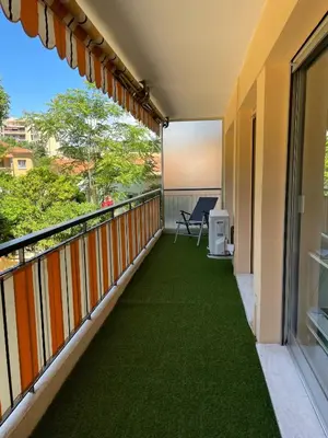 a balcony with green flooring on a building at GuestRoom - Chambre d'hôte in Le Cannet