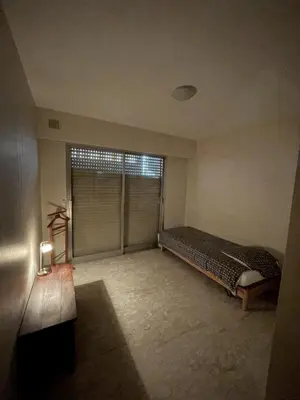 a bedroom with a bed and a large window at GuestRoom - Chambre d'hôte in Le Cannet