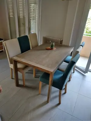 a dining room table with chairs and a wooden table at Le jasmin du Riou in Cannes