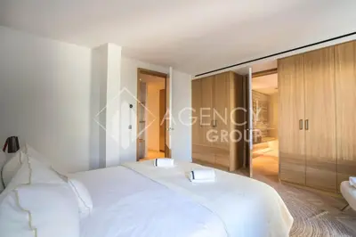 a bedroom with a white bed and wooden cabinets at Superbe Appartement, Croisette in Cannes