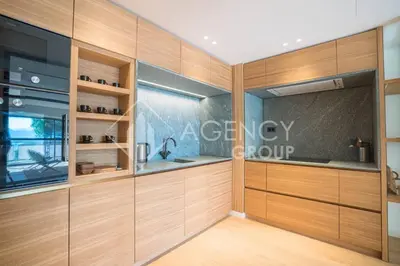 a kitchen with wooden cabinets and a sink at Superbe Appartement, Croisette in Cannes