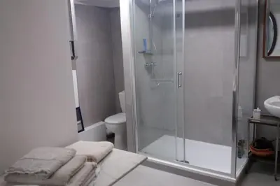 a bathroom with a shower and a toilet and towels at Grand studio de 30m2 !central !spacieux !différent ! in Cannes