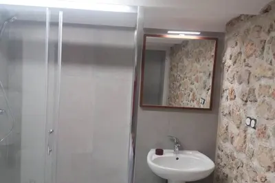 a bathroom with a shower and a sink and a mirror at Grand studio de 30m2 !central !spacieux !différent ! in Cannes