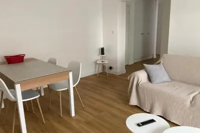a living room with a table and a couch at Beautiful family cocoon of 65 m close to the sea in Cannes