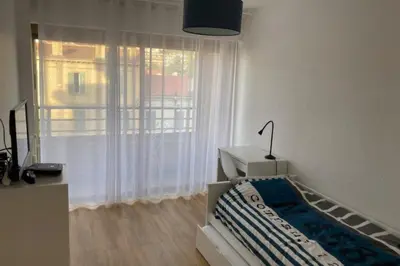 a bedroom with a bed and a large window at Beautiful family cocoon of 65 m close to the sea in Cannes