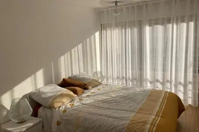 a bedroom with a bed in front of a window at Beautiful family cocoon of 65 m close to the sea in Cannes