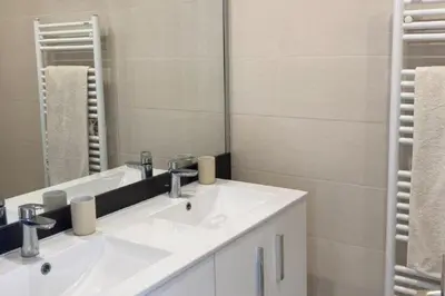 a bathroom with two sinks and a mirror at Beautiful family cocoon of 65 m close to the sea in Cannes