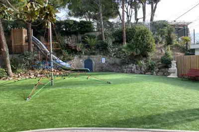 a playground with a slide in a yard at Beautiful family cocoon of 65 m close to the sea in Cannes