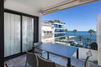 a balcony with a table and chairs and a view of the ocean at Apartment Lara Light apartment with an incredible view in Cannes