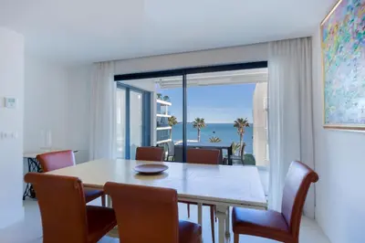 a dining room with a table and a view of the ocean at Apartment Lara Light apartment with an incredible view in Cannes