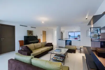 a living room with a couch and a table at Apartment Lara Light apartment with an incredible view in Cannes