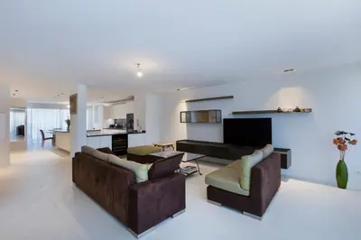a living room with two couches and a tv at Apartment Lara Light apartment with an incredible view in Cannes